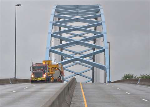 A Crane Rental Corp dual-lane trailer travelling over a suspension bridge on a journey from Oklahoma