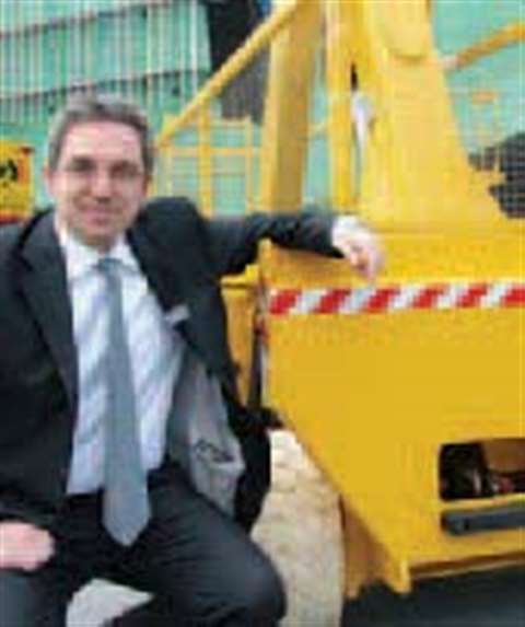 Alexandre Saubot at Intermat next to a Holland Lift scissor.