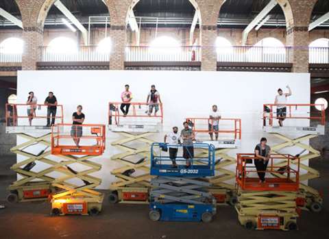 Artists get ready to paint the town in Rio de Janeiro aboard Mills’ aerial work platforms. Photo cre
