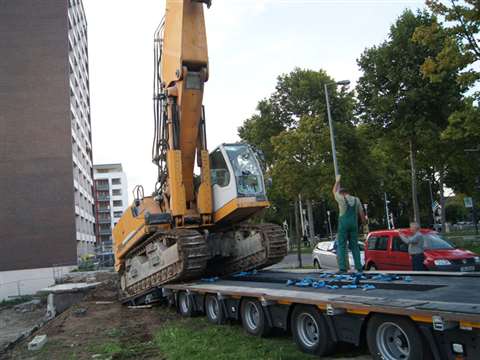 The Liebherr crawler excavator is driven onto the trailer’s platform using double ramps