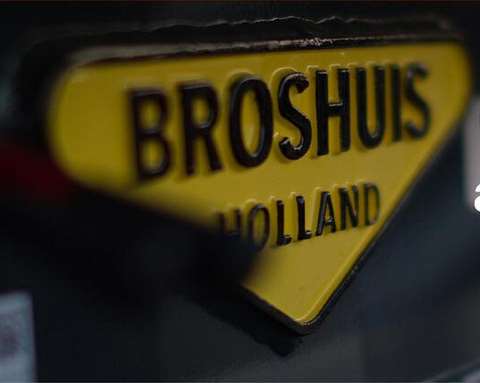 Broshuis yellow triangular product plate or badge with black lettering
