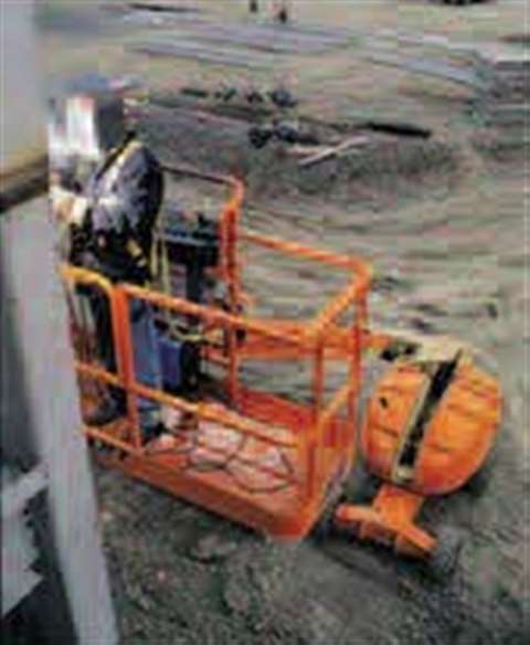 A worker in a JLG boom wearing a lanyard to provide restraint.