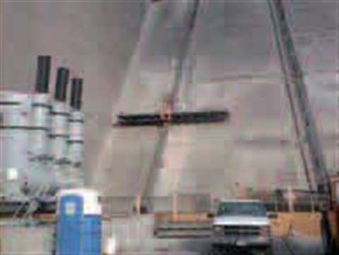 The mast climbers provide access to repair the concrete face of the dam.