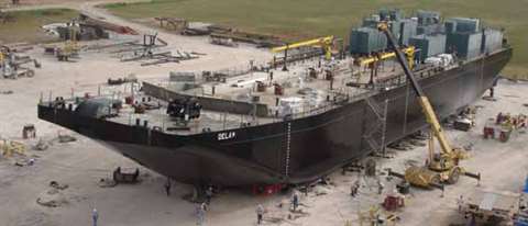 Pictured above: Trailers are positioned underneath the tank barge that is supported at height on sti