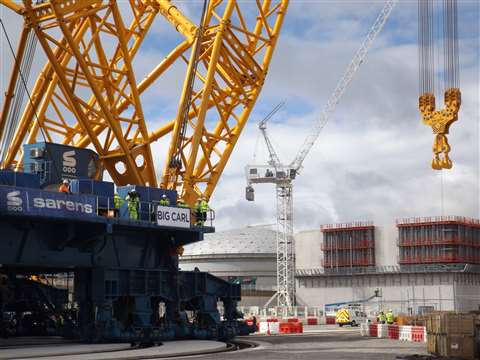 One of its key lifts will be moving prefabricated reactor building components from inside the domed building (seen here between Big Carl and the luffing jib tower crane) where they are being assembled and stored and slewing them into the new reactor build