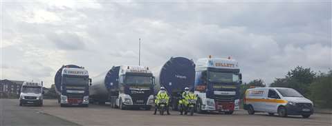 One of Collett's convoys with a police escort before setting off on one of the 171 transportation journeys.